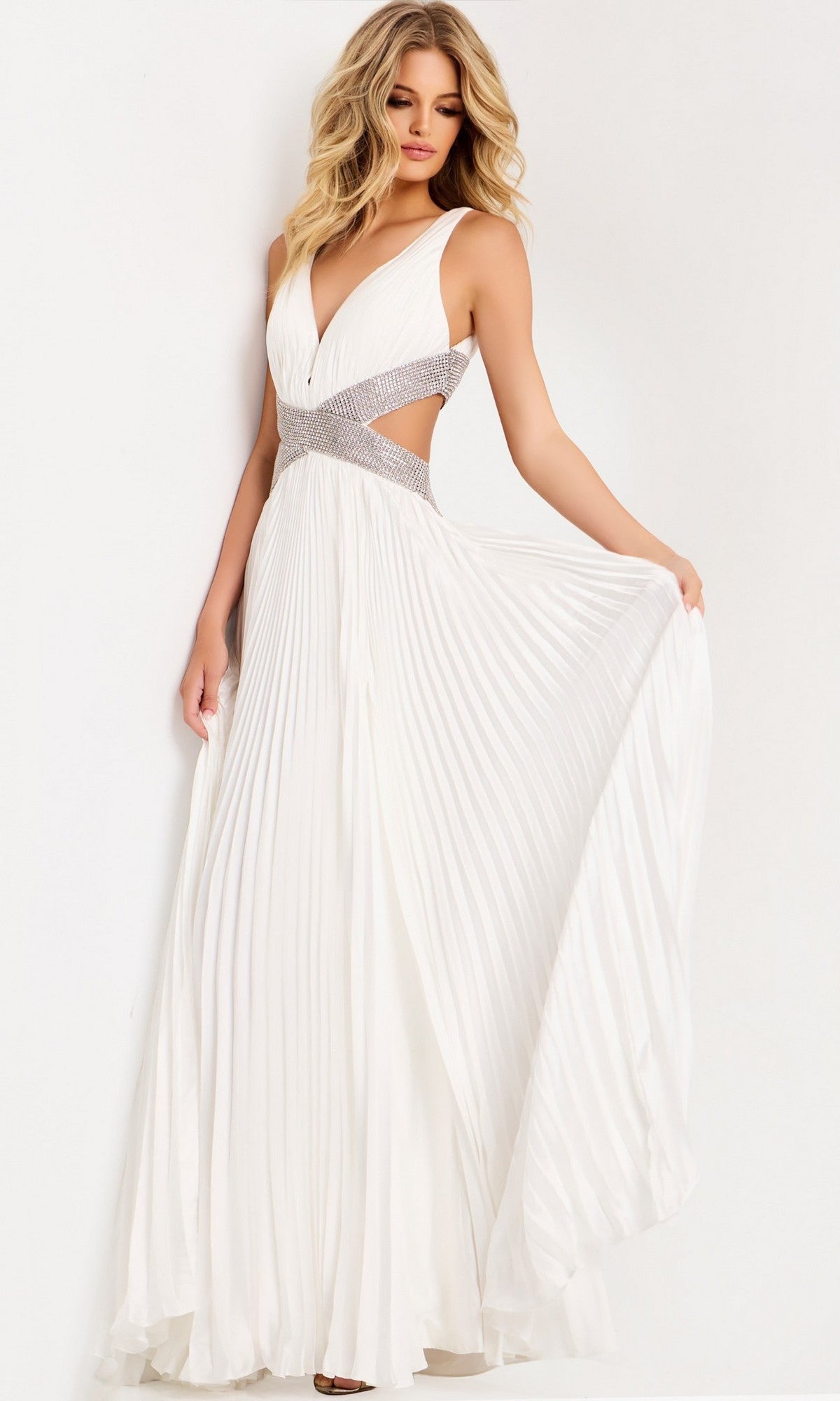 A woman wearing the Jovani 42811 Long Prom Dress, featuring sleeveless chiffon, a plunging neckline, silver embellished waistband, and cut-out sides, stands against a plain background.